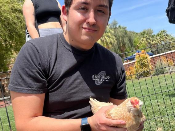 Student holding chicken