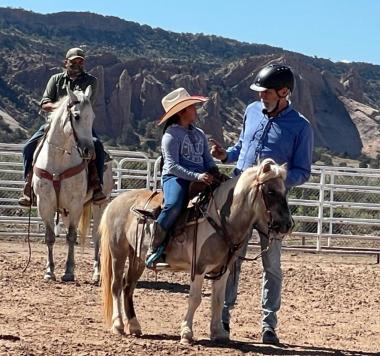 clinician gives instructions to youth rider on pony
