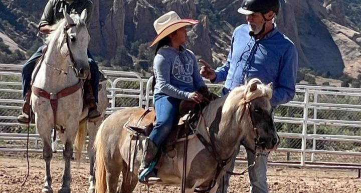 clinician gives instructions to youth rider on pony