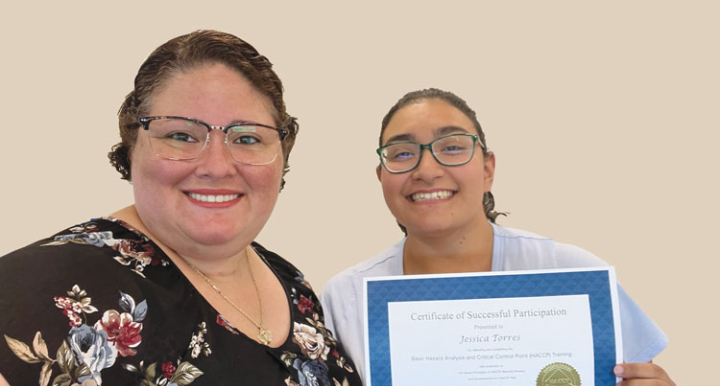 Dr. Margie Sanchez-Vega presents certificate to Jessica Torres