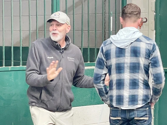Man standing facing forward next to man standing facing backward