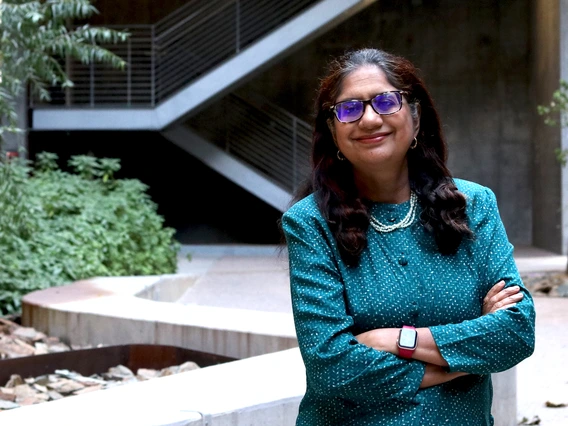 Sadhana Ravishankar poses in the courtyard of ENR2 Building on UArizona main campus