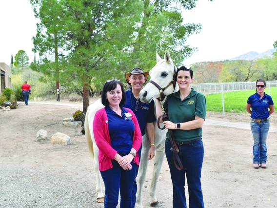 three people with horse